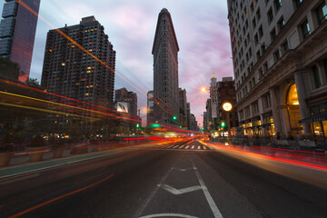 Traffic in front Flatiron Building at Flatiron District at dawn.