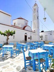 Photo of a traditional Greek tavern outside the Church of Virgin Malamatenia on the Cycladic island...