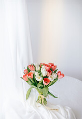 Red tulips in a white interior - 768991326