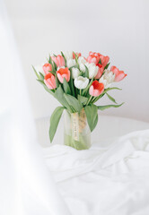 Red tulips in a white interior - 768991548