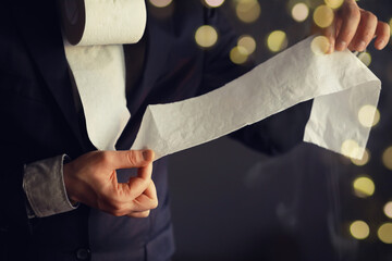 Businessman Holding a pile of Toilet Paper, copy space. Toilet papers is the new currency concept.