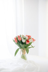 Red tulips in a white interior - 768991936