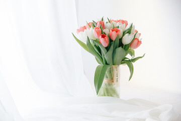 Red tulips in a white interior - 768992152
