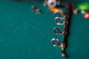 Fishing rods, wobblers, baubles and hooks on a table.