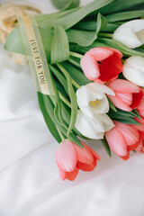 Red tulips in a white interior - 768992950