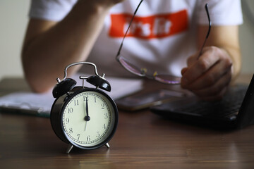 Alarm clock on the table. Time concept. Being late for work and school. - obrazy, fototapety, plakaty