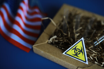 American flag and biohazard sign. The concept of American biolabs and research centers. - 768997386