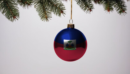 New Year's ball with the flag of Haiti on a Christmas tree branch isolated on white background. Christmas and New Year concept.