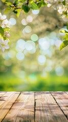 in garden outdoors beautiful spring background with green lush young foliage and flowering branches in sunlight with an empty wooden table on nature





