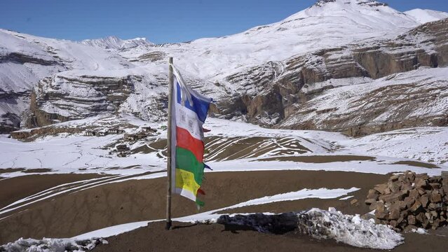 a buddhist flag swaying in the wind in mountains of Spiti Valley, Himachal Pradesh, India