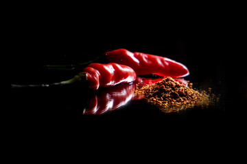 chili powder isolated on black or dark background