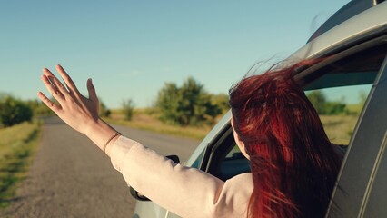 girl rides car with her hand out window, opens window, driving car, wind freedom sunset, car...