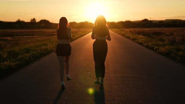 two friends running sunset, team group girls running sunset, silhouette athletic girls, teamwork gorgeous slim caucasian young, professional athletes, sports runner, wellness, cardio workout workout