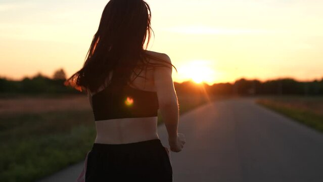 silhouette sports  girl running legs along road sunset, young asian women training outdoors, enjoying life, runner athlete's leg, sportswoman morning jogging, running, jogging on top at sunset, smile