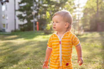 Cute toddler standing and playing outdoor