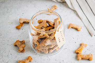 Homemade and healthy pumpkin dog bone cookies. Some on cooling rack with some on a plate. Top view