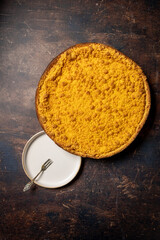 Dutch 'Kruimelvlaai' on a old rustic wooden table. Top view of a dutch pie. 