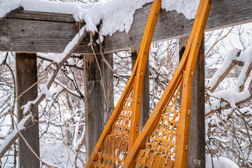 Detail of classic Huron snowshoes on a wooden deck