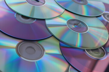 collection of compact discs laid out, overlapping each other