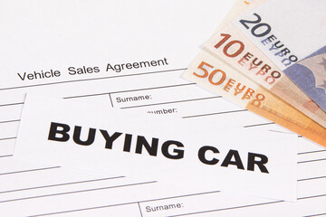 Vehicle sales agreement, inscription buying car and euro banknotes. Sales, buying new or used car