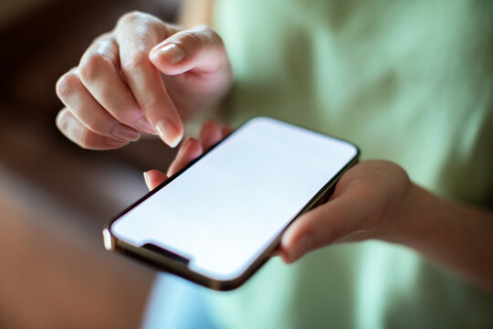 Top view of woman holding smartphone with blank screen