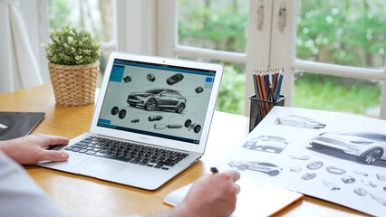Car design engineer analyze car prototype for automobile business at home office. Automotive engineering designer carefully analyze, finding flaws and improvement for car design with laptop Synchronos - obrazy, fototapety, plakaty