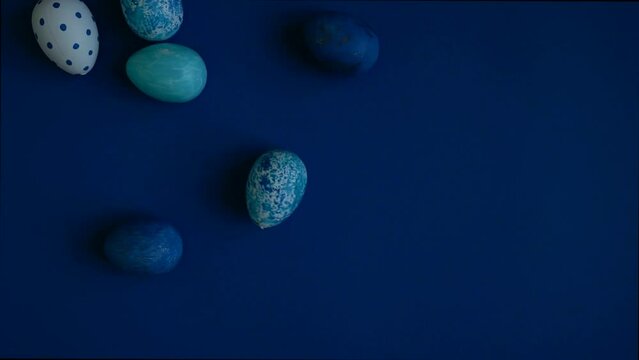 Group of Easter eggs painted with blue patterns. Blue background. Easter Egg rolling