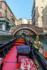 Gondola ride through the canals with view from inside the boat at the bridge Ponte Santa Maria...