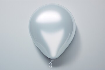 a white balloon on a white surface - obrazy, fototapety, plakaty