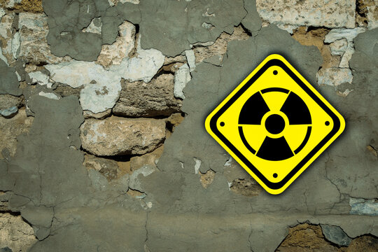 Radioactive sign on old cracked wall. Hazard symbol