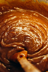 cooked golden-colored caramel with a spoon in the middle