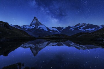 Mountain reflected in lake under night sky, creating electric blue horizon