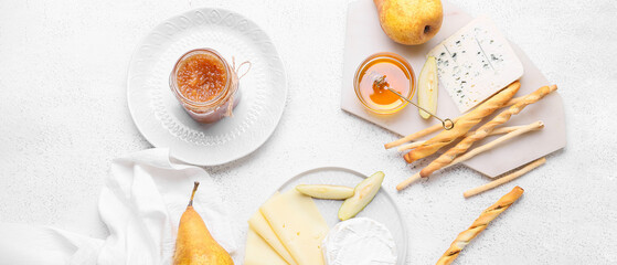 Composition with tasty pear jam, cheese and grissini on white background