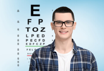 Vision test. Man in glasses and eye chart on light blue background