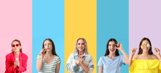 Group of young women with tasty candies on color background