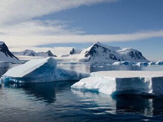 Fototapeta na wymiar Antarctic landscape with glaciers and snow-covered ice floes at sea. Antarctica. The polar pole.