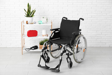 Empty wheelchair with shelving unit near white brick wall