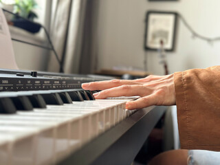 hands on keyboard, person playing the piano