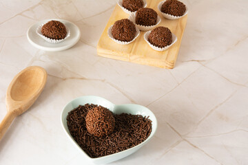 Chocolate truffle ball Brigadeiro brazilian candy and chocolate flakes aerial view clean background