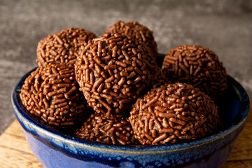 Brigadeiro brazilian chocolate balls party candy with chocolate flakes front view dark background