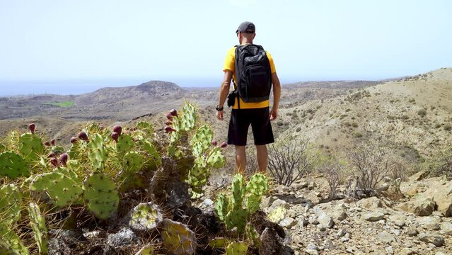 Young adult trekking in the arid mountains of the Canary Islands