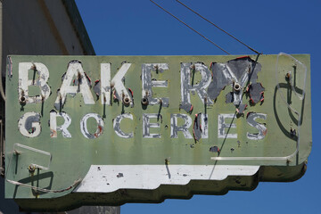 Old faded defunct broken former neon sign BAKERY GROCERIES