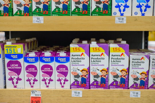Aurrera and Great Value brand dairy products on a stand at local market.