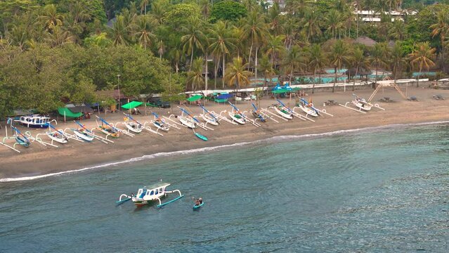 Aerial top view of traditional Indonesian fisher boats standing on the beach in Lombok island, West Nusa Tenggara, Indonesia. Aerial 4K drone video footage
