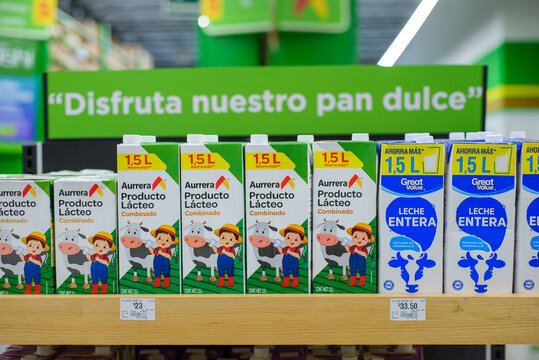 Aurrera and Great Value brand dairy products on a stand at local market.