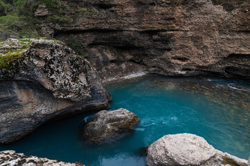 blue water in the river in the mountains in the Aksu canyon in Kazakhstan in spring