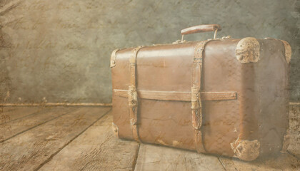 Vintage suitcase on a wooden floor, grunge background, travel concept