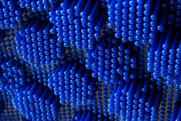 Lots of blue plastic parts on dark. Abstract background or backdrop. Concept of the unknown and...
