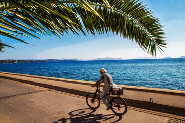 Blurred motion person  on Spetses road  with amazing garden  - one of the best Greek islands  in...