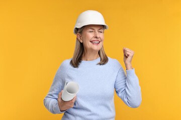 Architect in hard hat with draft on orange background